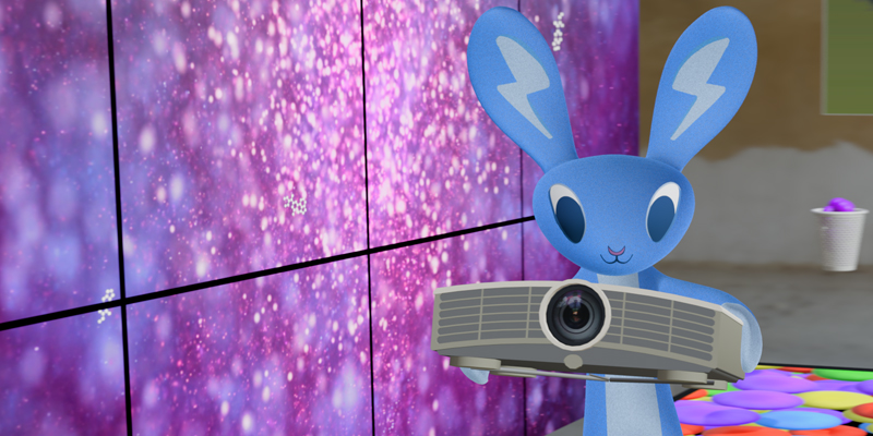 Blue LUMOplay bunny holding a short throw projector.